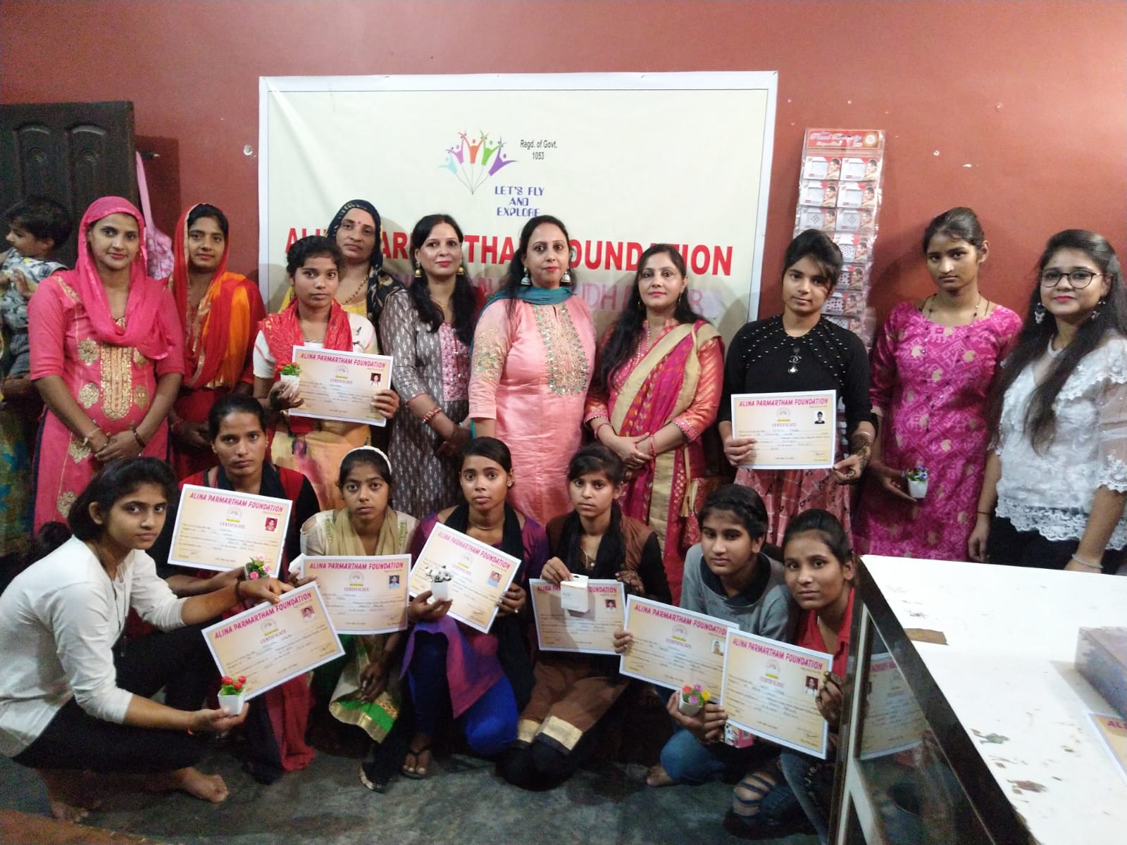 Women holding certificates from a skill development programme at Alina Parmartham Foundation